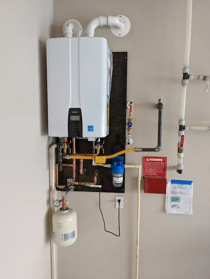 Professional plumber installing copper piping in a Baker City home